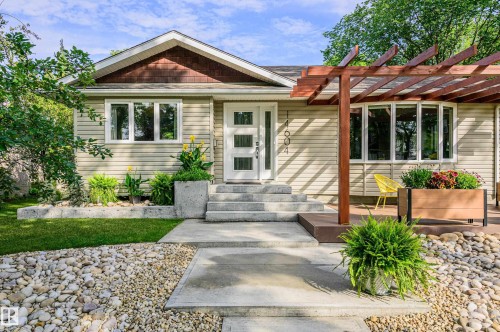 Exterior featuring light-colored siding, a prominent wood pergola, and a bay window - 14604 92A Avenue, Edmonton, AB - Outdoor