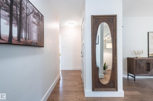 Hardwood-finish flooring throughout, featuring crisp white baseboards and walls - 14604 92A Avenue, Edmonton, AB - Indoor Photo Showing Other Room
