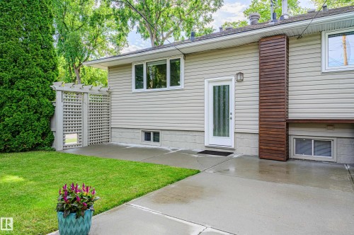 Rear exterior with light-colored siding and white trim windows - 14604 92A Avenue, Edmonton, AB - Outdoor