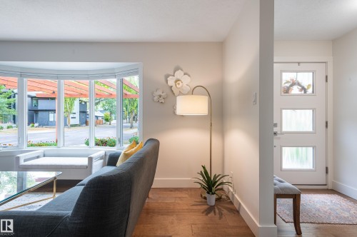 Bay window with integrated seating, hardwood flooring, recessed lighting, and a contemporary entryway door with multiple glass panes - 14604 92A Avenue, Edmonton, AB - Indoor Photo Showing Other Room