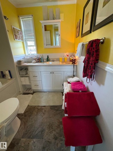 Bathroom featuring a single-sink vanity with white cabinetry, a built-in medicine cabinet. - 115 2Nd Street E, Derwent, AB - Indoor Photo Showing Bathroom