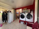 laundry area featuring a washer and dryer, patterned flooring, and a window for natural light. Located in front entry. - 115 2Nd Street E, Derwent, AB  - Indoor Photo Showing Laundry Room 