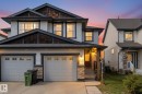 Modern exterior featuring horizontal siding, stone accents, and dark trim - 21818 99A Avenue, Edmonton, AB  - Outdoor With Facade 