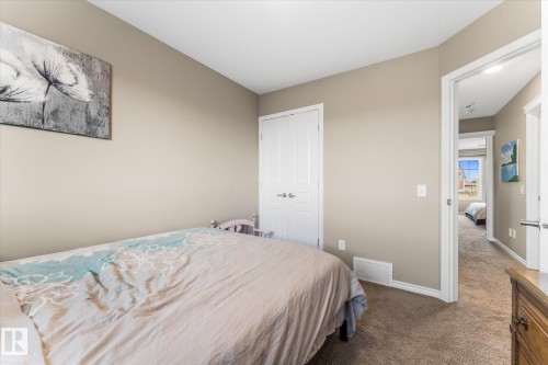 Interior room featuring neutral wall paint, white trim, a white paneled door, and carpet flooring - 21818 99A Avenue, Edmonton, AB - Indoor Photo Showing Bedroom