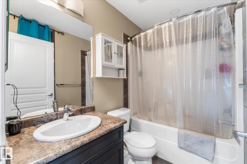 Bathroom featuring a white bathtub, toilet, and vanity with a built-in sink - 21818 99A Avenue, Edmonton, AB - Indoor Photo Showing Bathroom