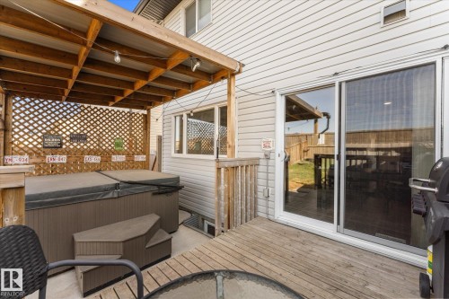 Outdoor decking featuring a covered patio structure and a built-in hot tub - 21818 99A Avenue, Edmonton, AB - Outdoor With Deck Patio Veranda With Exterior