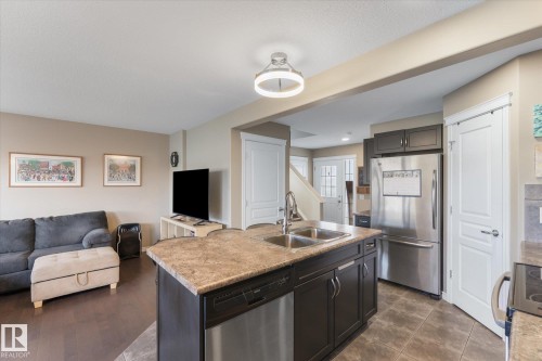 Kitchen island with a dual basin stainless steel sink and integrated dishwasher - 21818 99A Avenue, Edmonton, AB - Indoor Photo Showing Kitchen With Double Sink