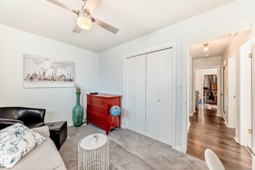 Room featuring light gray carpet, white walls, and a ceiling fan with integrated lighting - 3611 108 Street, Edmonton, AB - Indoor