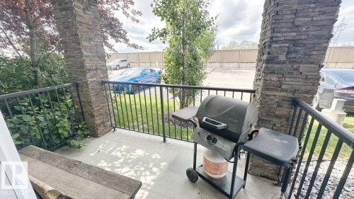 This property features a patio with a concrete surface and a black metal railing - 1112 9363 Simpson Drive, Edmonton, AB - Outdoor
