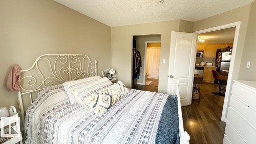 This property features an open layout with hardwood flooring and a neutral color palette - 1112 9363 Simpson Drive, Edmonton, AB - Indoor Photo Showing Bedroom