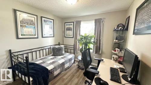 This room features light-colored walls and wood-look flooring - 1112 9363 Simpson Drive, Edmonton, AB - Indoor Photo Showing Other Room