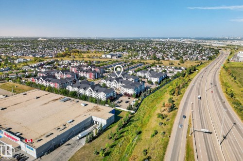 Aerial perspective showcasing multi-story residential buildings with dark roofs and light-colored facades - 215 2208 44 Avenue, Edmonton, AB - Outdoor With View