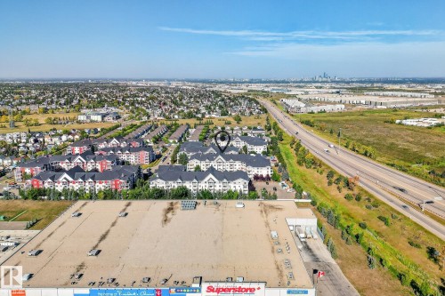 Aerial perspective showcasing a complex of multi-story buildings with varied facades and dark roofs - 215 2208 44 Avenue, Edmonton, AB - Outdoor With View