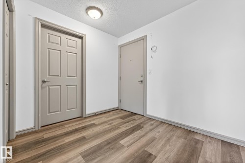 Wood-finish flooring throughout - 215 2208 44 Avenue, Edmonton, AB - Indoor Photo Showing Other Room