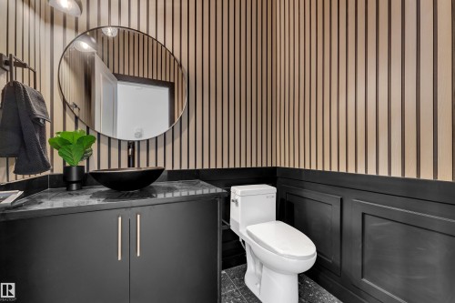 Powder room featuring contemporary vertical wood paneling and dark wainscoting - 259 Linden Loop, Leduc, AB - Indoor Photo Showing Bathroom