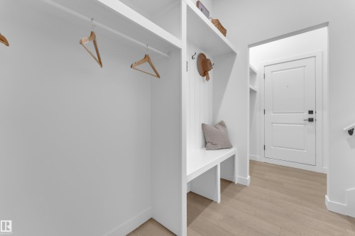 Built-in mudroom-style storage featuring a bench, shelving, and wall hooks - 259 Linden Loop, Leduc, AB - Indoor