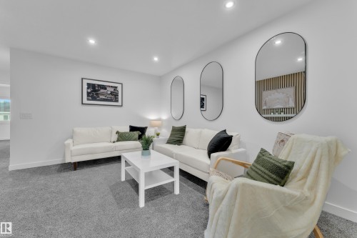 Spacious room featuring neutral carpeting, recessed ceiling lighting, and crisp white walls - 259 Linden Loop, Leduc, AB - Indoor Photo Showing Living Room