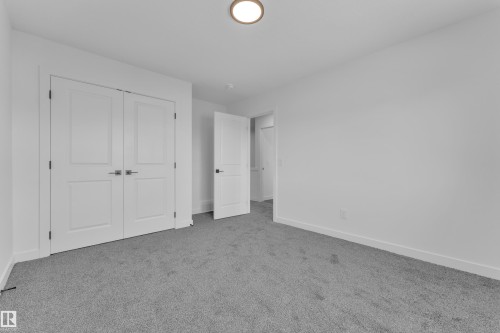 Spacious room featuring light gray carpet flooring, white walls, and bright white trim - 259 Linden Loop, Leduc, AB - Indoor Photo Showing Other Room
