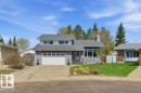 Split-level residence featuring a two-car garage, gray exterior finish, and a shingle roof - 8608 22 Ave, Edmonton, AB  - Outdoor With Facade 