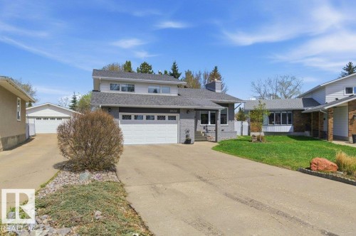 Two-story property featuring a gray exterior finish, an attached two-car garage, and a long concrete driveway - 8608 22 Ave, Edmonton, AB - Outdoor With Facade