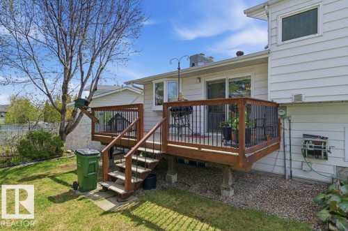 Spacious rear deck featuring wood-finish decking and dark balusters - 8608 22 Ave, Edmonton, AB - Outdoor With Deck Patio Veranda With Exterior