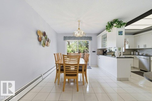 Open-concept dining area with tile flooring and a patio door - 8608 22 Ave, Edmonton, AB - Indoor