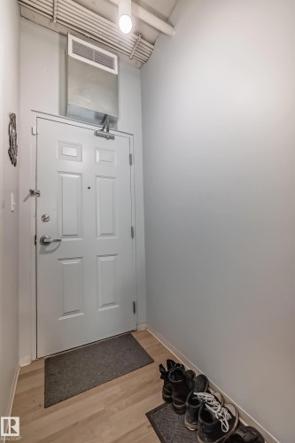 Light-colored wood-finish flooring provides a bright entryway - 1207 10024 Jasper Avenue, Edmonton, AB - Indoor Photo Showing Other Room