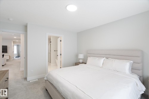 Spacious room with light neutral wall tones, recessed ceiling lighting, and soft gray carpeting - 1214 Eaton Lane, Edmonton, AB - Indoor Photo Showing Bedroom