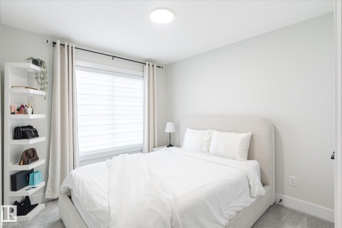 Comfortable room featuring light gray wall paint and a large window with blinds and drapes - 1214 Eaton Lane, Edmonton, AB - Indoor Photo Showing Bedroom