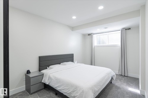 Carpeted bedroom with a window, recessed lighting, and white walls - 1214 Eaton Lane, Edmonton, AB - Indoor Photo Showing Bedroom