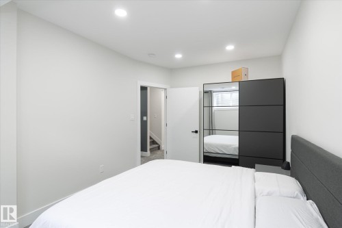Recessed lighting illuminates this room featuring light gray walls, white trim, and gray carpeting - 1214 Eaton Lane, Edmonton, AB - Indoor Photo Showing Bedroom