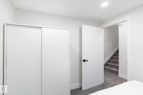 Bedroom featuring white walls, gray carpet, and a flush-mounted ceiling light - 1214 Eaton Lane, Edmonton, AB - Indoor
