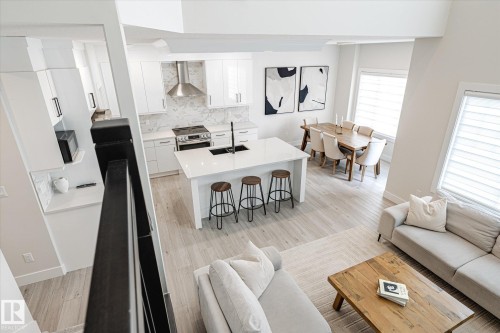 Open-concept living space with light wood-finish flooring - 1214 Eaton Lane, Edmonton, AB - Indoor