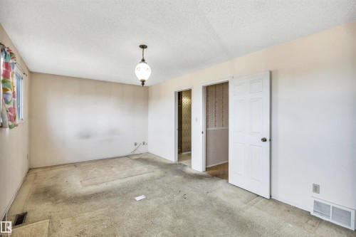 Room featuring a window, textured ceiling, and a hanging light fixture - 6723 39 Avenue, Edmonton, AB - Indoor Photo Showing Other Room