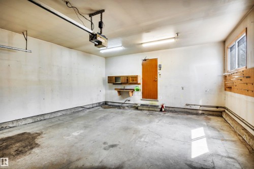 Spacious garage with concrete flooring, overhead lighting, and an automatic garage door opener system - 6723 39 Avenue, Edmonton, AB - Indoor Photo Showing Garage