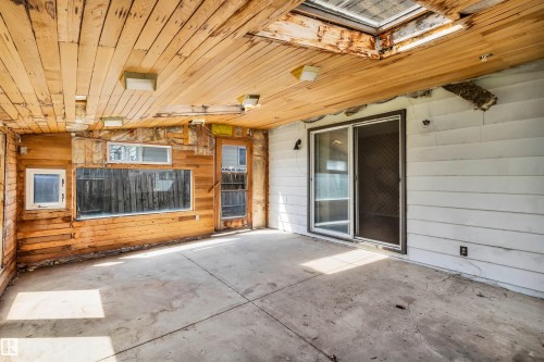 Enclosed patio space featuring a concrete floor, wood plank ceiling, and a skylight - 6723 39 Avenue, Edmonton, AB - Outdoor With Exterior