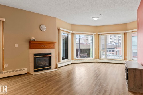 206 10809 Saskatchewan Drive Nw, Edmonton, AB - Indoor Photo Showing Living Room With Fireplace