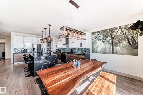 Modern kitchen and dining area featuring wood-finish flooring - 5263 47 Ave, Calmar, AB - Indoor Photo Showing Dining Room
