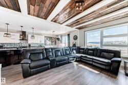 Open-concept living area featuring a wood-finish coffered ceiling with recessed lighting - 