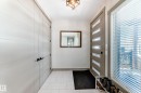Entryway featuring a modern front door with frosted glass panels, white tile flooring, and a contemporary ceiling fixture - 5263 47 Ave, Calmar, AB  - Indoor Photo Showing Other Room 