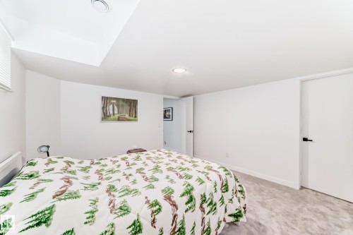 Carpeted room with white walls, recessed lighting, and a white interior door with black hardware - 5263 47 Ave, Calmar, AB - Indoor Photo Showing Bedroom