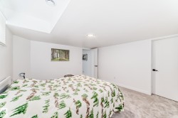 Carpeted room with white walls, recessed lighting, and a white interior door with black hardware - 