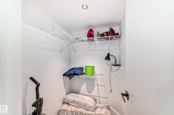 Compact storage area featuring white walls and a recessed ceiling light - 