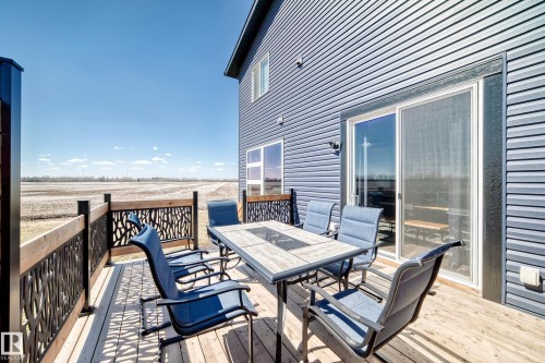 Wood-finish deck with decorative metal railing panels - 5263 47 Ave, Calmar, AB - Outdoor With Deck Patio Veranda With Exterior