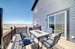 Wood-finish deck with decorative metal railing panels - 