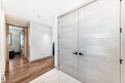 Entryway featuring large light-toned doors with matte black hardware - 