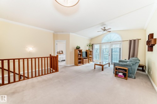 Carpeted open-concept living area with vaulted ceilings and crown molding - 40 13808 155 Avenue, Edmonton, AB - Indoor Photo Showing Other Room