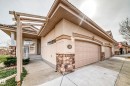 Stucco exterior with stone accents and a terracotta-style roof - 40 13808 155 Avenue, Edmonton, AB  - Outdoor 