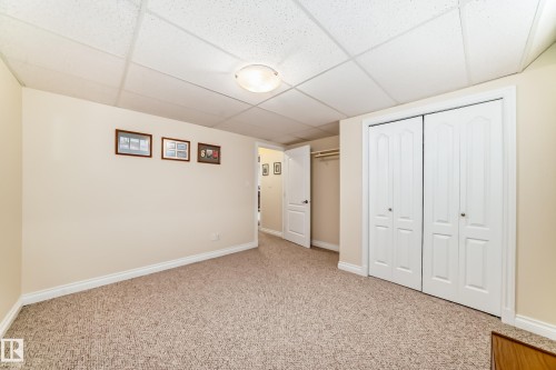 Carpeted room with neutral wall tones and a drop ceiling - 40 13808 155 Avenue, Edmonton, AB - Indoor