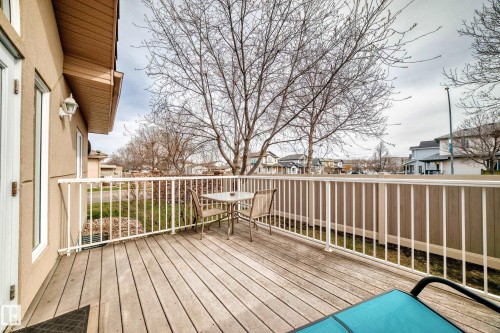 Expansive wood-finish deck with white railings and privacy screening - 40 13808 155 Avenue, Edmonton, AB - Outdoor With Deck Patio Veranda With Exterior